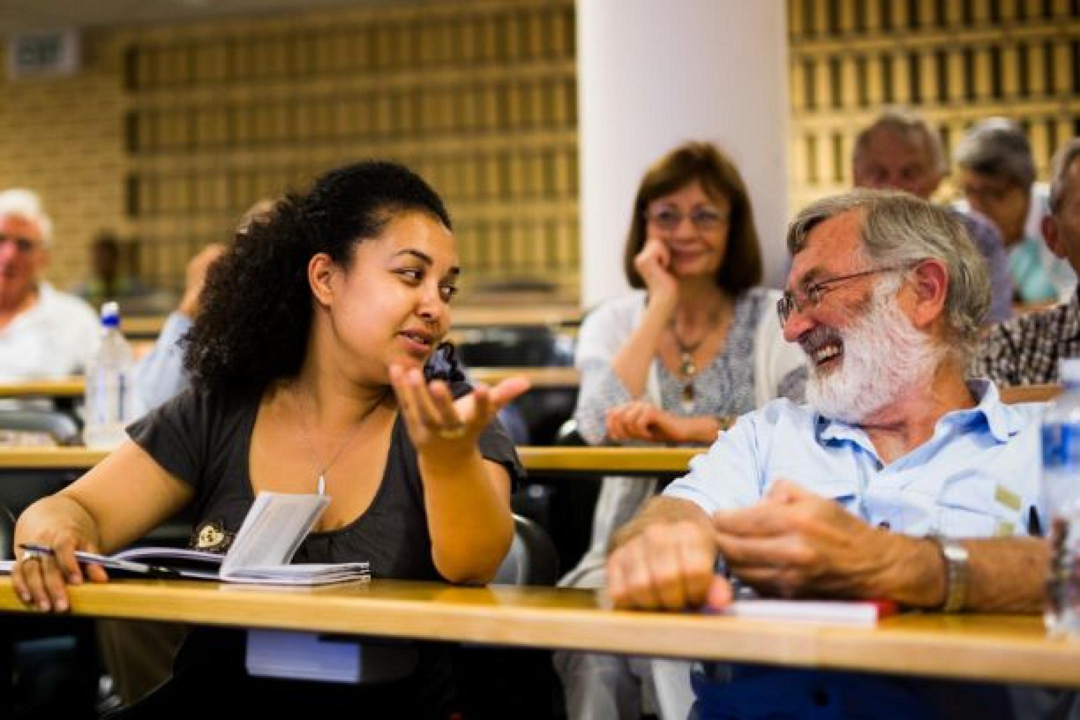 Summer school participants in conversation during a lecture
