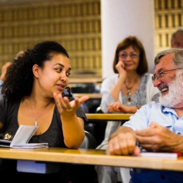 Summer school participants in conversation during a lecture